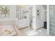Elegant bathroom showcasing a corner tub, white cabinetry, and refined decor with glass block window accents at 6014 Luana S Ln, Gulfport, FL 33707