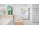 Vintage bathroom featuring a large window, soaking tub, vanity, and natural light at 6014 Luana S Ln, Gulfport, FL 33707