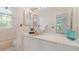 Charming bathroom with dual mirrors, a classic sink, and a view of the serene outdoors at 6014 Luana S Ln, Gulfport, FL 33707