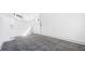 Large bedroom featuring white walls, patterned carpet, and ample closet space with neutral paint at 6014 Luana S Ln, Gulfport, FL 33707