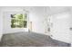 Bright bedroom with high ceilings, large windows, and built-in storage with unique patterned carpet at 6014 Luana S Ln, Gulfport, FL 33707