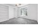 Bright bedroom with large window and built-in shelving providing plenty of storage space at 6014 Luana S Ln, Gulfport, FL 33707