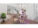 Dining area featuring stylish decor, an open floor plan, modern staircase and views to the living room, kitchen, and plant wall at 6014 Luana S Ln, Gulfport, FL 33707