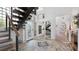 Inviting foyer featuring a unique glass block staircase, open staircase, marble flooring, and modern finishes at 6014 Luana S Ln, Gulfport, FL 33707
