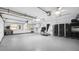 Large garage with epoxy flooring, storage, and workbench at 6014 Luana S Ln, Gulfport, FL 33707