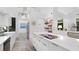Contemporary kitchen offers sleek white cabinetry, stainless steel appliances, modern finishes, and an open design concept at 6014 Luana S Ln, Gulfport, FL 33707