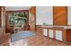 Unique kitchen design with wood paneling, a large window, and a charming breakfast nook at 6014 Luana S Ln, Gulfport, FL 33707