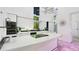 Stylish kitchen features modern black and white cabinetry, granite countertops, and stainless steel appliances with unique lighting at 6014 Luana S Ln, Gulfport, FL 33707