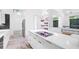 A kitchen showcasing stainless steel appliances, a white quartz countertop island, and sleek modern cabinetry at 6014 Luana S Ln, Gulfport, FL 33707