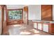 Sun-drenched room features wood paneled walls, tile flooring, and a large window with lush green views at 6014 Luana S Ln, Gulfport, FL 33707