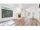 Bright living room with fireplace, high ceilings, large windows, and French doors at 6014 Luana S Ln, Gulfport, FL 33707