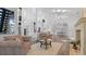 Bright open-plan living room boasts vaulted ceilings, modern furnishings, and seamless flow into the kitchen and dining areas at 6014 Luana S Ln, Gulfport, FL 33707