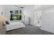 Spacious main bedroom with large window, neutral tones, and access to a bathroom and large wardrobe at 6014 Luana S Ln, Gulfport, FL 33707