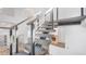 Floating staircase features cable railings, wooden treads, and modern design with ample natural light at 6014 Luana S Ln, Gulfport, FL 33707