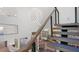 Contemporary staircase with wooden treads, cable railings, and modern lighting with views of living spaces at 6014 Luana S Ln, Gulfport, FL 33707