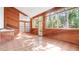 Bright sunroom featuring wood-paneled walls and ceiling and tile flooring at 6014 Luana S Ln, Gulfport, FL 33707