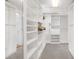 Spacious walk-in closet with custom shelving and storage, providing ample space for organization at 6014 Luana S Ln, Gulfport, FL 33707