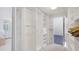 Well-organized walk-in closet with custom shelving and storage, with a bathroom located at the end at 6014 Luana S Ln, Gulfport, FL 33707