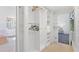 Well-organized walk-in closet with shelves, clothes racks, and access to bathroom and main bedroom at 6014 Luana S Ln, Gulfport, FL 33707