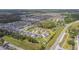 Extensive aerial view of community featuring many homes, manicured landscaping, ponds, and a swimming pool at 6700 Devlin Ln, Wesley Chapel, FL 33545