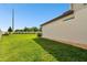 Spacious backyard with lush green grass, privacy fence, and the exterior of the home at 6700 Devlin Ln, Wesley Chapel, FL 33545