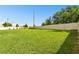 Expansive backyard featuring a well-maintained lawn and a clean white fence at 6700 Devlin Ln, Wesley Chapel, FL 33545