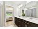 Modern bathroom features a double sink vanity with stone countertop and decorative mirror at 6700 Devlin Ln, Wesley Chapel, FL 33545