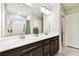 Modern bathroom features a double sink vanity with stone countertop and decorative mirror at 6700 Devlin Ln, Wesley Chapel, FL 33545