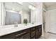 Modern bathroom features a double sink vanity with stone countertop and decorative mirror at 6700 Devlin Ln, Wesley Chapel, FL 33545
