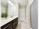Modern bathroom features a double sink vanity with stone countertop and decorative mirror at 6700 Devlin Ln, Wesley Chapel, FL 33545