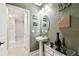 Stylish half-bathroom featuring decorative wall art and a pedestal sink with chrome faucet at 6700 Devlin Ln, Wesley Chapel, FL 33545
