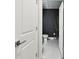 Modern bathroom features dark accent wall and tiled flooring in an elegant design at 6700 Devlin Ln, Wesley Chapel, FL 33545
