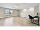 Spacious bonus room with ample natural light, desk space, and modern flooring at 6700 Devlin Ln, Wesley Chapel, FL 33545
