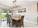 Dining room featuring a wood table, wicker chairs, decorative lighting, and sliding door to the backyard at 6700 Devlin Ln, Wesley Chapel, FL 33545