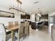 Cozy dining area with a modern chandelier, seamlessly connected to the kitchen and living room at 6700 Devlin Ln, Wesley Chapel, FL 33545