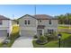 Beautifully landscaped home with a well-maintained lawn and attached two-car garage at 6700 Devlin Ln, Wesley Chapel, FL 33545