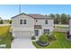 Charming two-story home featuring a well-manicured lawn and a two-car garage at 6700 Devlin Ln, Wesley Chapel, FL 33545