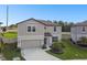 Attractive two-story home with lush front lawn, landscaping, and attached two-car garage at 6700 Devlin Ln, Wesley Chapel, FL 33545