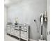 Hallway featuring a mirrored console table with decor accents and a mounted vacuum cleaner at 6700 Devlin Ln, Wesley Chapel, FL 33545