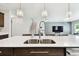 Bright kitchen showcasing a stainless steel sink, quartz countertops, and modern lighting fixtures at 6700 Devlin Ln, Wesley Chapel, FL 33545