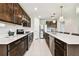 Modern kitchen with sleek cabinetry, stainless steel appliances, a large island, and pendant lighting at 6700 Devlin Ln, Wesley Chapel, FL 33545