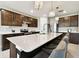 Stylish kitchen featuring a large island with seating, pendant lights, and ample cabinet space at 6700 Devlin Ln, Wesley Chapel, FL 33545