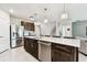 Spacious kitchen featuring dark wood cabinetry, stainless steel appliances, and a large center island at 6700 Devlin Ln, Wesley Chapel, FL 33545