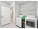 Bright laundry room with modern washer and dryer and ample storage space at 6700 Devlin Ln, Wesley Chapel, FL 33545