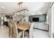 Inviting open floor plan featuring a dining area, kitchen, and living room with modern decor at 6700 Devlin Ln, Wesley Chapel, FL 33545