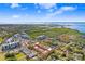 Community aerial view featuring nearby waterways and wetlands under a blue sky with white clouds at 6823 S Kissimmee St, Tampa, FL 33616
