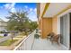 Balcony with chairs, white railing, and view of neighborhood street at 6823 S Kissimmee St, Tampa, FL 33616