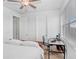 Bedroom featuring natural light from a window and contains a bed and desk at 6823 S Kissimmee St, Tampa, FL 33616