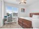 Bedroom features natural light from a window and contains a bed and desk at 6823 S Kissimmee St, Tampa, FL 33616