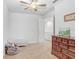 Bright bedroom featuring beige carpet, a ceiling fan, and lots of natural light at 6823 S Kissimmee St, Tampa, FL 33616